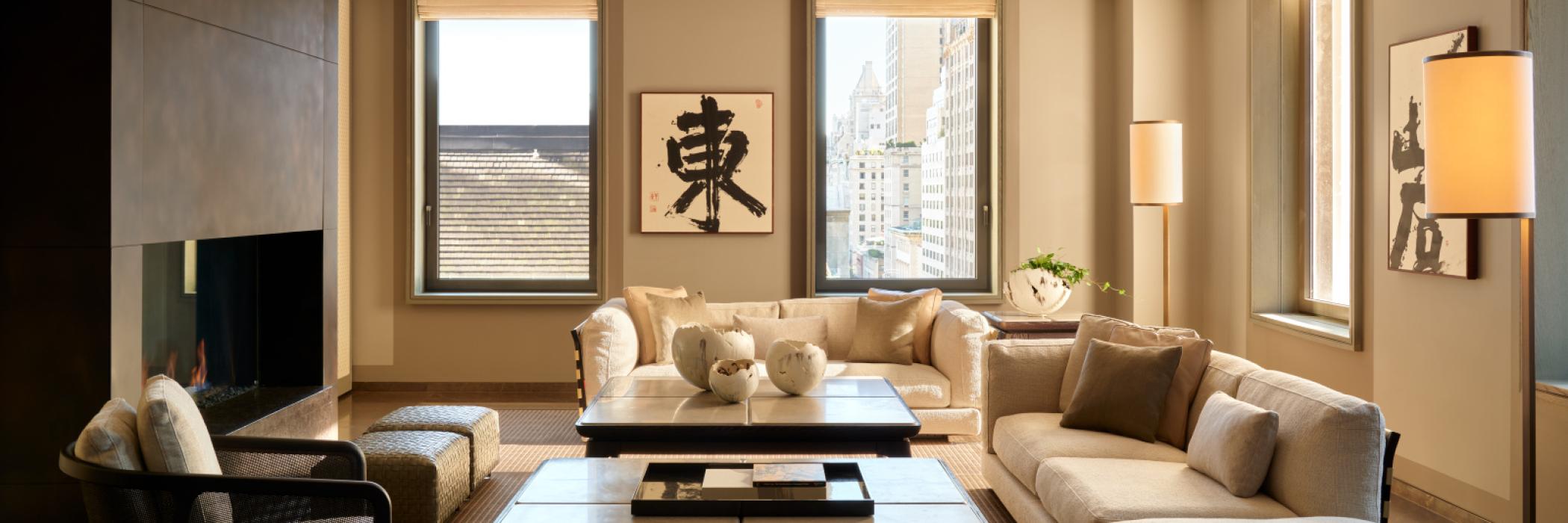 Elegant living room with modern furniture, large windows, and soft lighting.