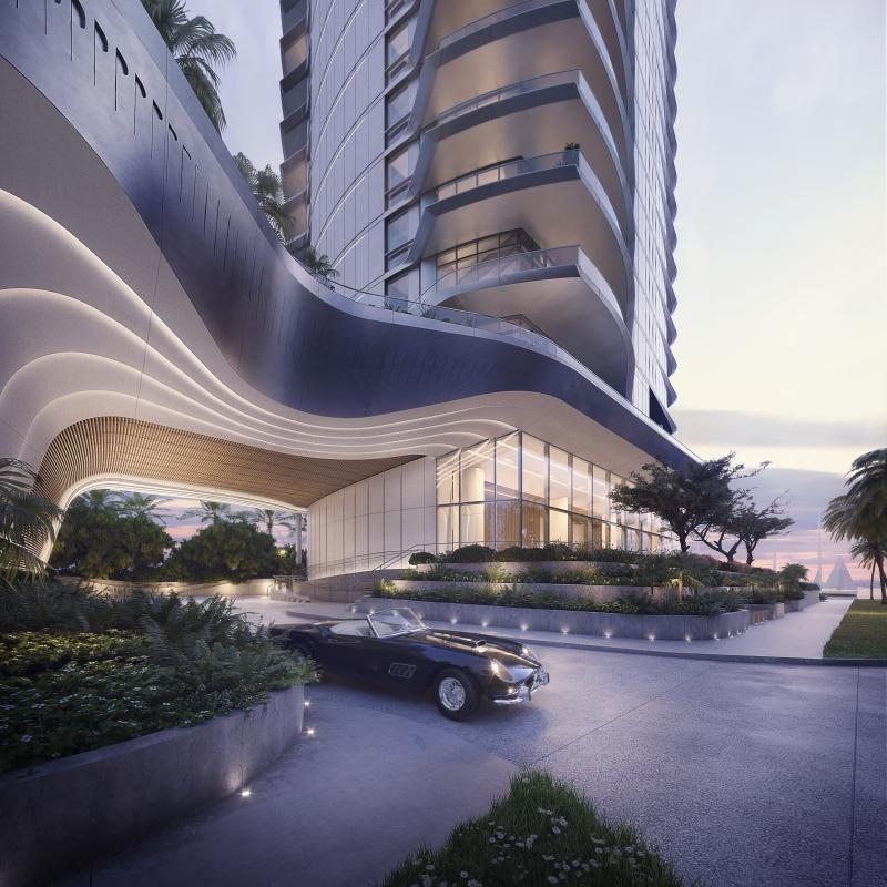 A sleek, modern high-rise entrance with curved architectural details, featuring a classic convertible parked in the driveway.